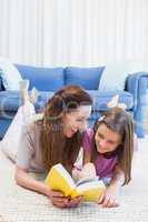 Mother and daughter reading on the floor