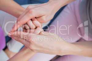 Mother and daughter touching hands