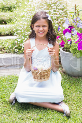 Happy girl collecting easter eggs