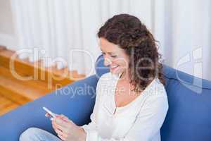 Smiling woman looking at her mobile phone