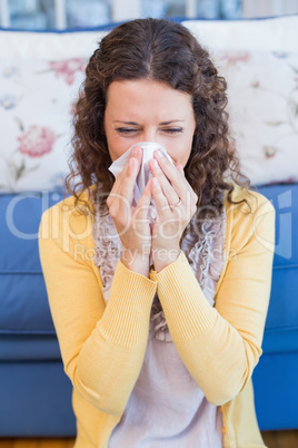 Sick woman blowing her nose