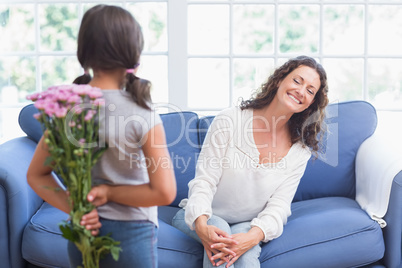 Cute girl offering flowers to her mother