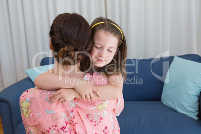 Little girl with her mother on sofa