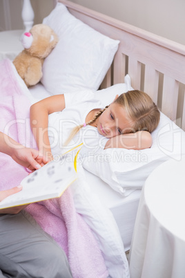 Mother reading daughter a bedtime story