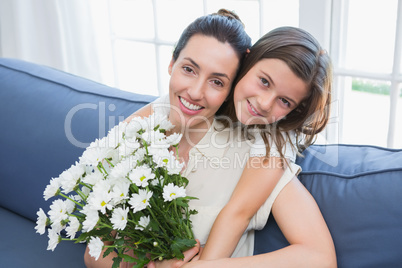 Mother and daughter smiling at camera