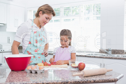 Mother and daughter baking together