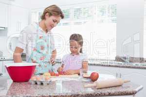 Mother and daughter baking together