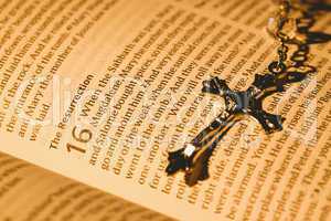 Open bible and silver crucifix