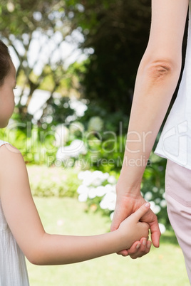 Mother and daughter holding hands