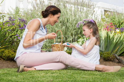 Mother and daughter collecting easter eggs