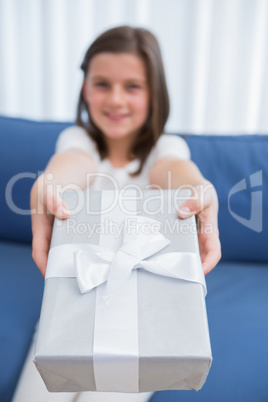 Little girl offering a silver gift