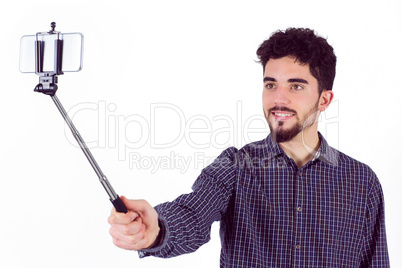 Casual man using a selfie stick