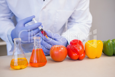 Scientist injecting vegetables