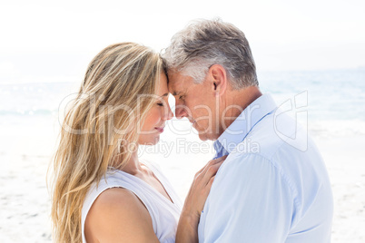 Happy couple standing by the sea and hugging each other