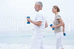 Fit couple lifting dumbbells