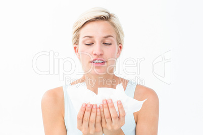 Sick woman holding tissues