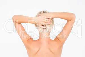 Beautiful topless woman touching her hair
