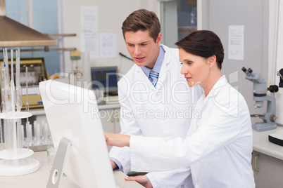 Scientists looking attentively at computer