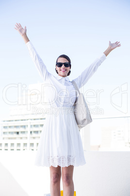 Happy woman raising her hands up