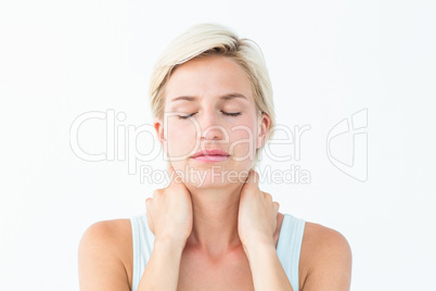 Woman with eyes closed suffering from neck ache
