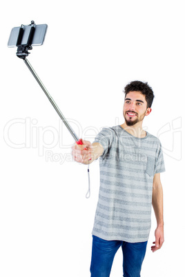 Casual man using a selfie stick