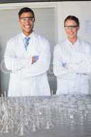 Smiling scientists looking at camera arms crossed