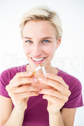 Pretty blonde breaking cigarette