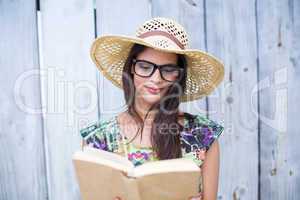 Smiling beautiful brunette reading a book