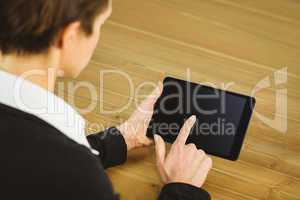 Businesswoman using tablet at desk