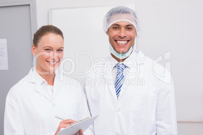 Happy scientist team smiling at camera