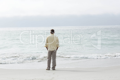 Thoughtful man standing by the sea