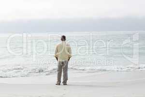 Thoughtful man standing by the sea