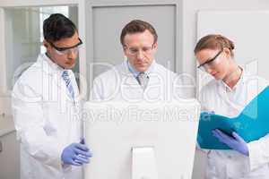 Scientists looking attentively at computer