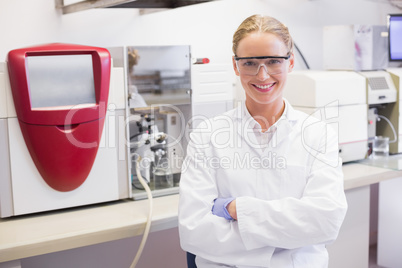 Smiling scientist looking at camera arms crossed