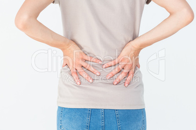 Woman having a back ache and holding her back
