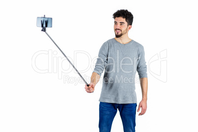 Casual man using a selfie stick