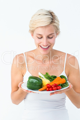 Beautiful woman holding vegetables plate