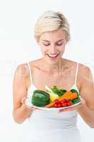 Beautiful woman holding vegetables plate