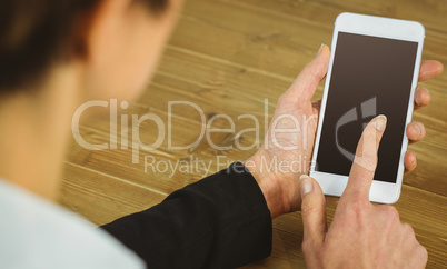 Businesswoman using phone at desk