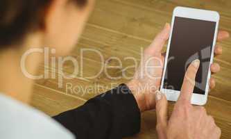 Businesswoman using phone at desk