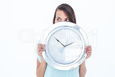 Pretty brunette holding a clock Pretty brunette holding a clock