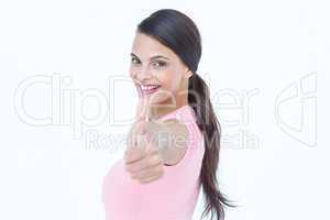 Beautiful woman looking at camera with thumb up