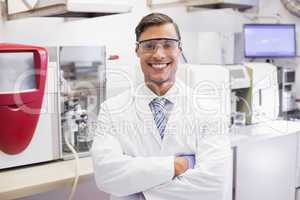 Smiling scientist looking at camera arms crossed