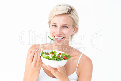 Beautiful blonde woman eating salad