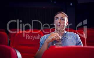 Young man watching a film