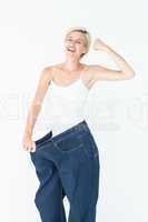 Smiling woman wearing too big jeans