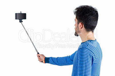 Casual man using a selfie stick