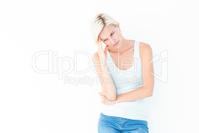 Depressed blonde woman with hand on temple