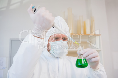 Scientist in protective suit doing experimentations