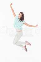 Pretty woman jumping looking at camera